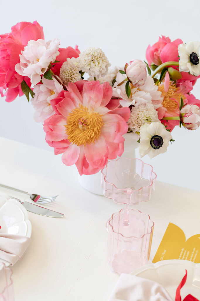 A Christmas table setting with pink & white flowers from hire society