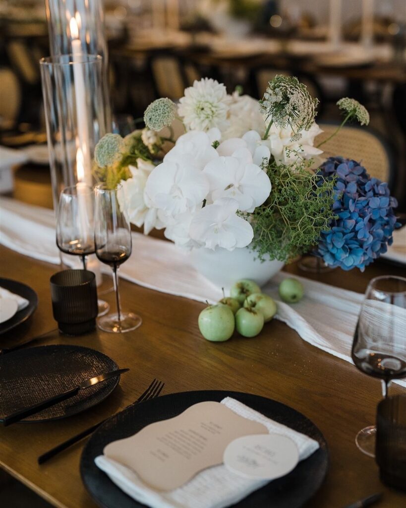 Close-up winter wedding table setting with assorted flower arrangement