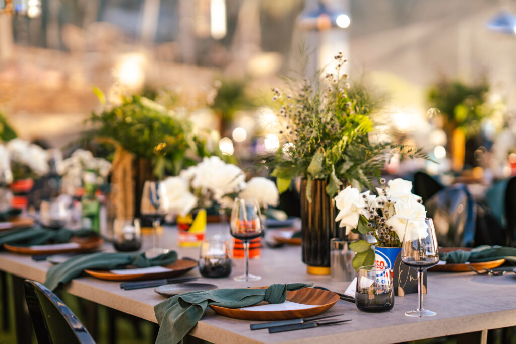 Close up of table setting with green linen napkins and black glassware