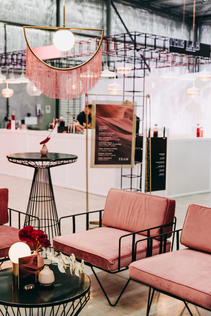Pink and comfortable corporate chairs in front of white bar